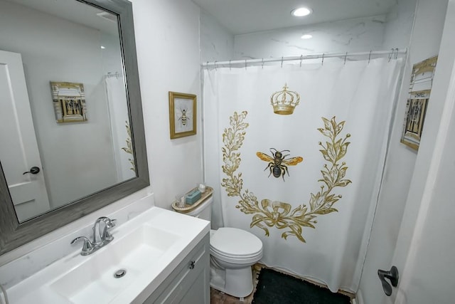 full bathroom with toilet and vanity