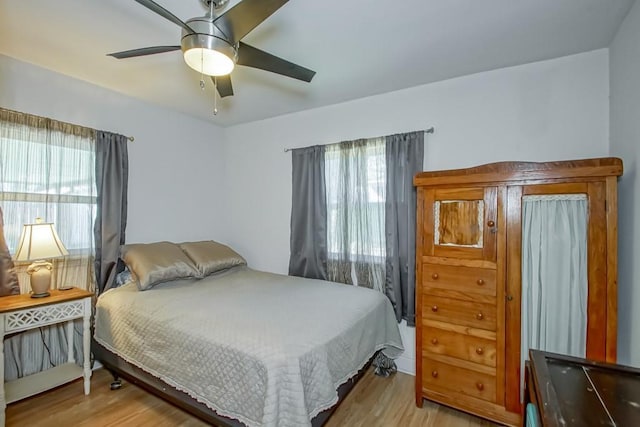 bedroom featuring light wood-style floors and ceiling fan