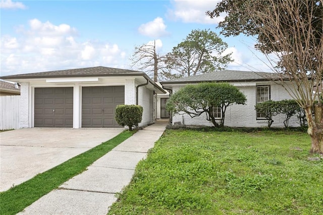 single story home featuring concrete driveway, brick siding, an attached garage, and a front yard