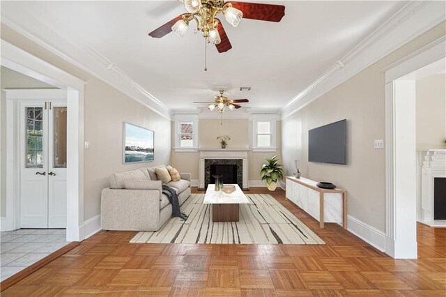 living room featuring ornamental molding, a fireplace, and baseboards