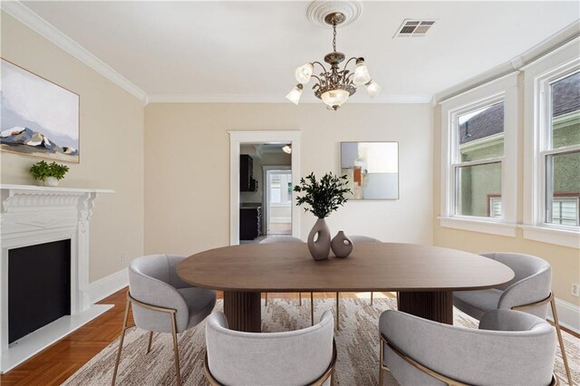 dining area featuring ornamental molding, a fireplace, visible vents, and baseboards