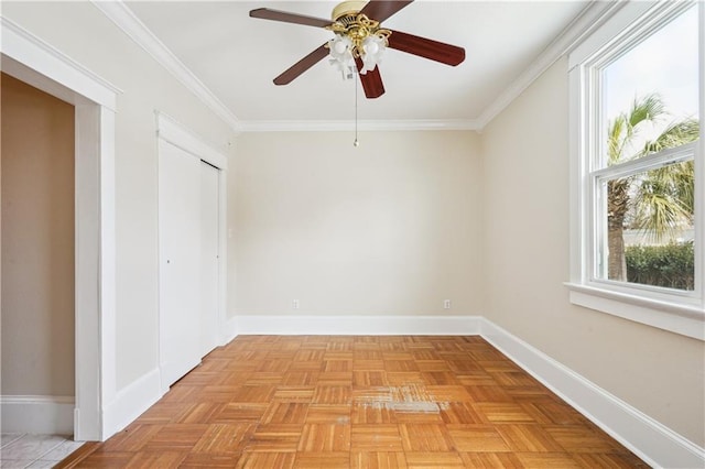 empty room featuring ornamental molding and baseboards