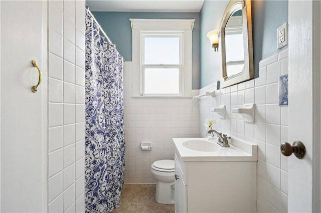 bathroom with toilet, a shower with shower curtain, tile walls, and vanity