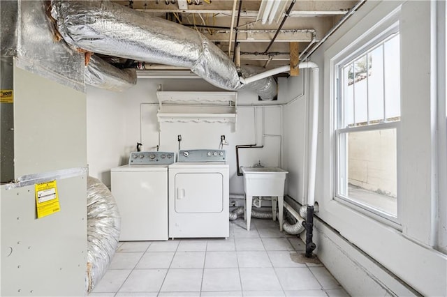 laundry room featuring a sink, laundry area, tile patterned flooring, and washer and dryer