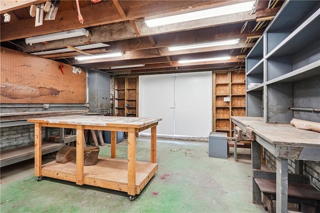 unfinished basement featuring a workshop area