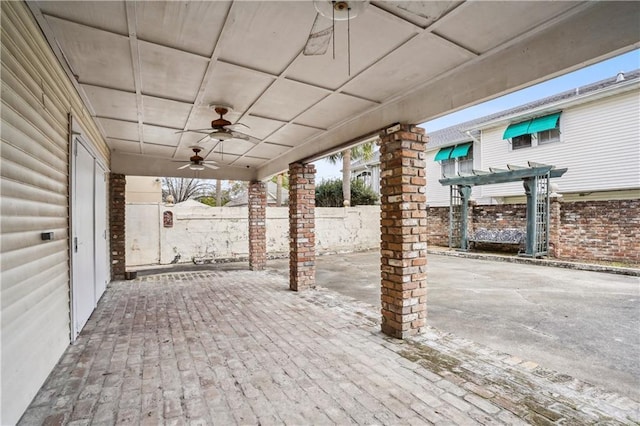 view of patio featuring fence and a ceiling fan