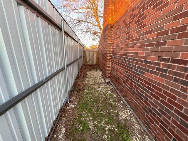 view of home's exterior featuring fence and brick siding