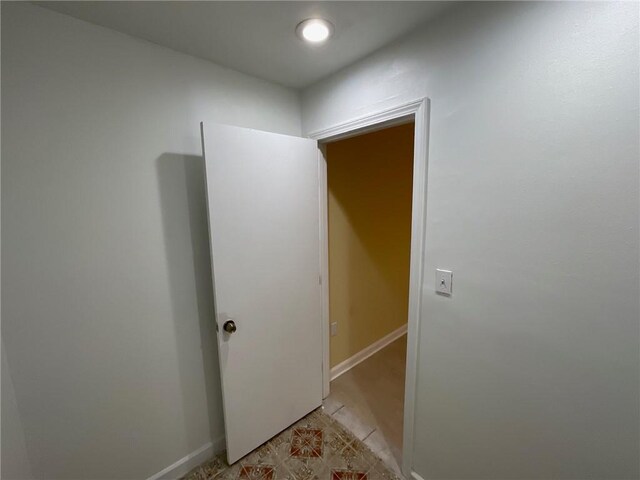 hallway featuring baseboards