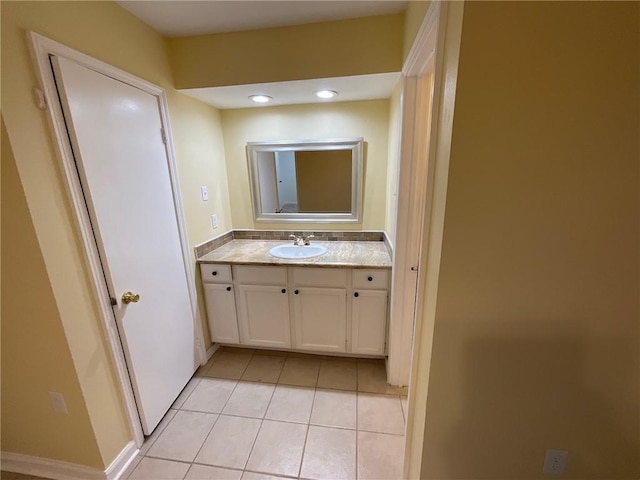 bathroom with tile patterned flooring, vanity, and recessed lighting