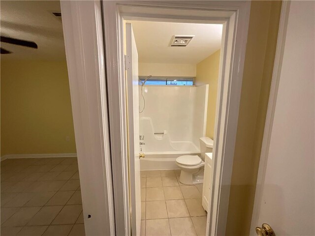 bathroom featuring toilet, visible vents, tub / shower combination, and tile patterned floors