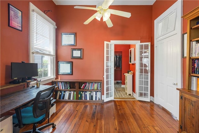 office with a ceiling fan, hardwood / wood-style floors, and french doors