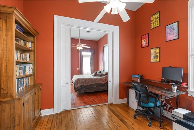 office with hardwood / wood-style flooring, ceiling fan, and baseboards