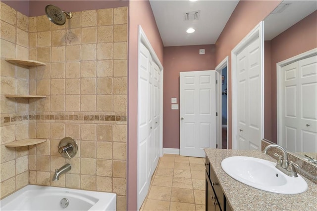 full bathroom featuring visible vents, bathing tub / shower combination, vanity, baseboards, and a closet