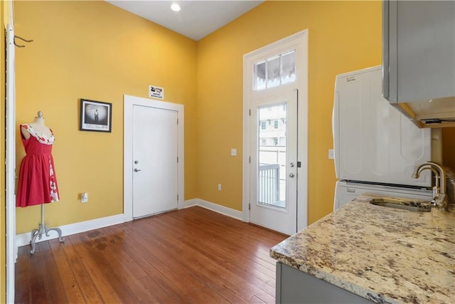 entrance foyer with dark wood-style flooring and baseboards