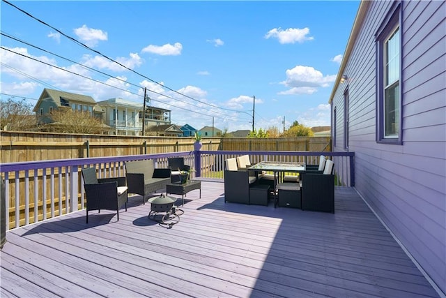 deck featuring outdoor dining area, outdoor lounge area, and fence