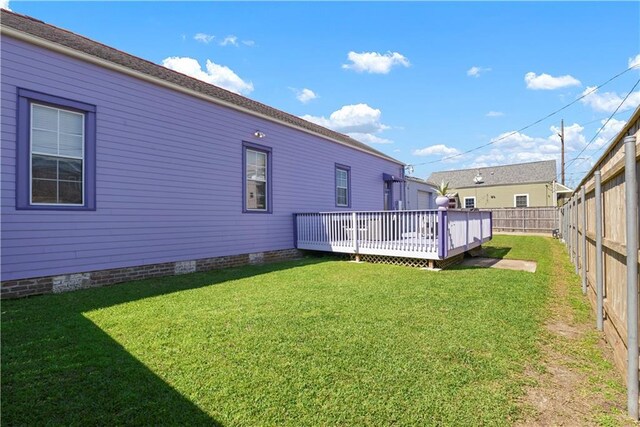 1026 Delaronde St, New Orleans, LA 70114 - rear view of property with a lawn, a fenced backyard, and a deck