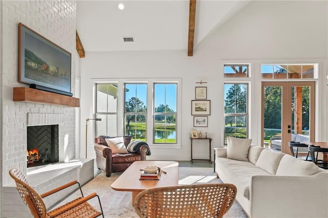 23648 Goodlife Ln, Covington, LA 70435 - living area featuring a brick fireplace, high vaulted ceiling, french doors, beamed ceiling, and a water view