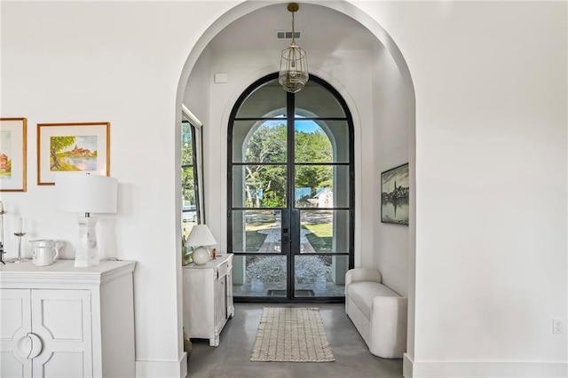 23648 Goodlife Ln, Covington, LA 70435 - entrance foyer with arched walkways, finished concrete floors, and french doors