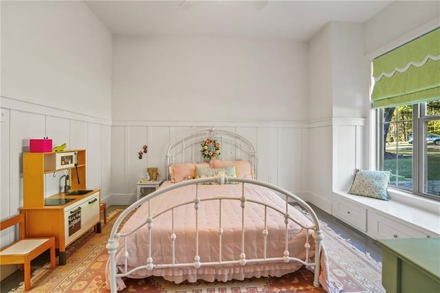 23648 Goodlife Ln, Covington, LA 70435 - bedroom with a decorative wall, light wood-style flooring, and wainscoting