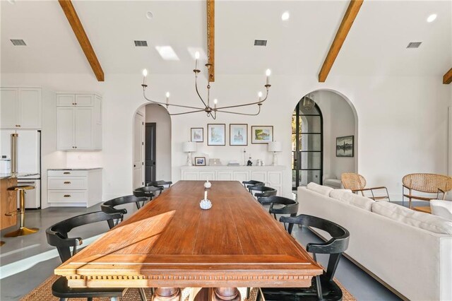 23648 Goodlife Ln, Covington, LA 70435 - dining area with arched walkways, a chandelier, and concrete flooring