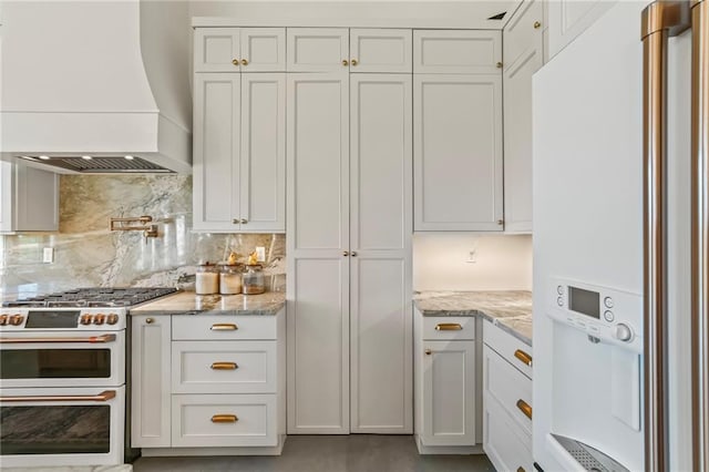23648 Goodlife Ln, Covington, LA 70435 - kitchen with white appliances, custom exhaust hood, decorative backsplash, white cabinetry, and light stone countertops