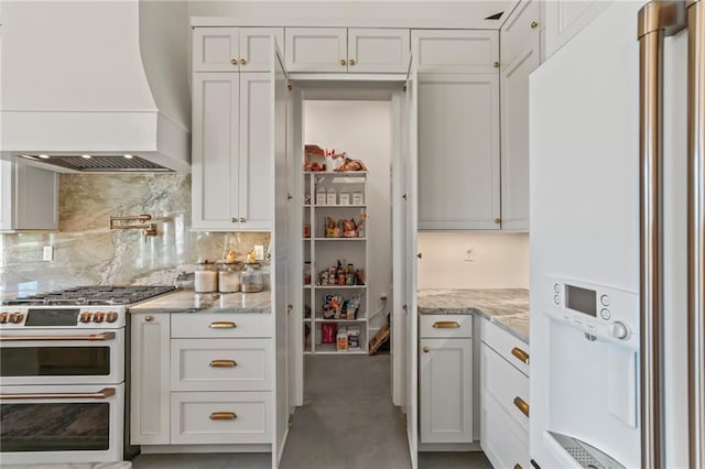 23648 Goodlife Ln, Covington, LA 70435 - kitchen with white appliances, premium range hood, decorative backsplash, and light stone counters