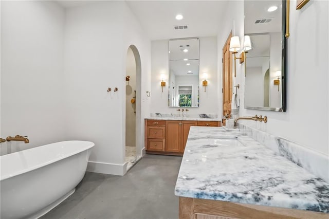 23648 Goodlife Ln, Covington, LA 70435 - bathroom featuring finished concrete floors, a freestanding bath, vanity, recessed lighting, and a walk in shower