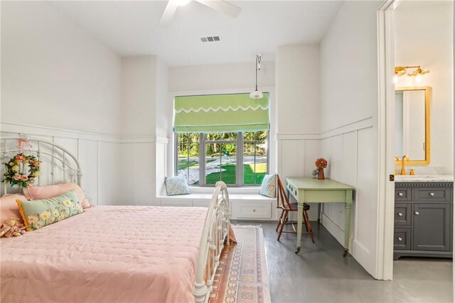 23648 Goodlife Ln, Covington, LA 70435 - bedroom featuring a decorative wall, a wainscoted wall, and ceiling fan