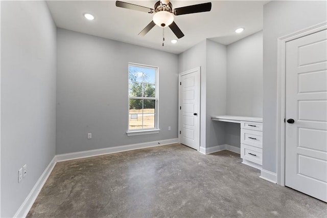 unfurnished bedroom with ceiling fan, recessed lighting, baseboards, built in study area, and unfinished concrete flooring