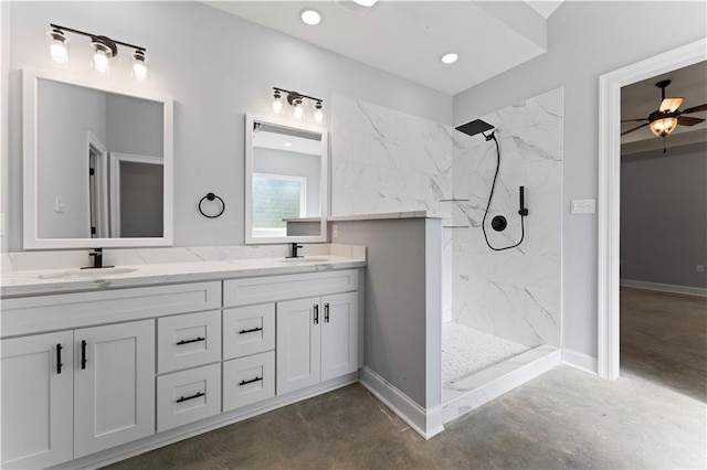 full bath featuring concrete floors, baseboards, a sink, and a marble finish shower