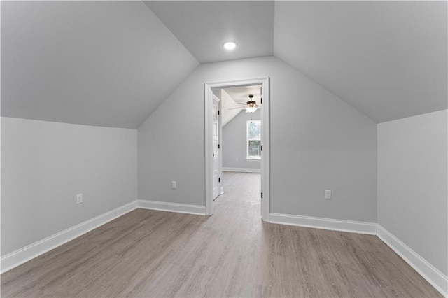 bonus room featuring lofted ceiling, baseboards, and wood finished floors