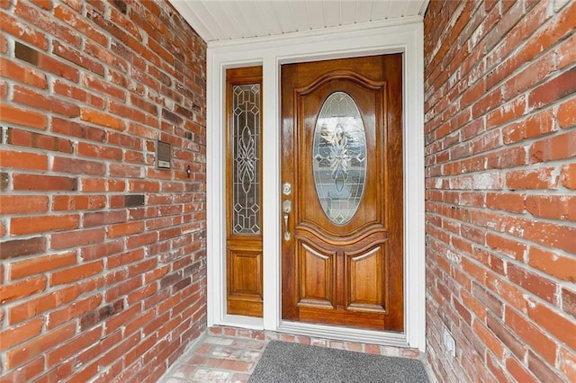 property entrance featuring brick siding