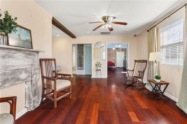 sitting room with ceiling fan with notable chandelier, visible vents, baseboards, and hardwood / wood-style flooring