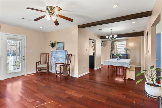 living area featuring beamed ceiling, wood finished floors, and visible vents