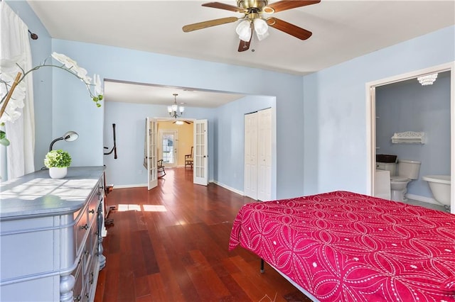 bedroom with baseboards, connected bathroom, dark wood-style flooring, french doors, and a closet