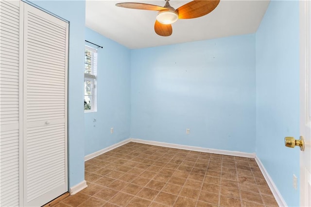 unfurnished bedroom with ceiling fan, baseboards, and a closet