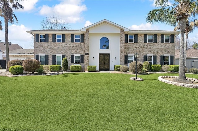 view of front of property with a front yard and brick siding