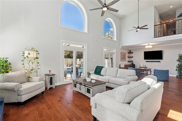 living room featuring dark wood-style floors and ceiling fan