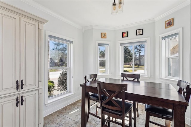 dining space featuring baseboards and ornamental molding