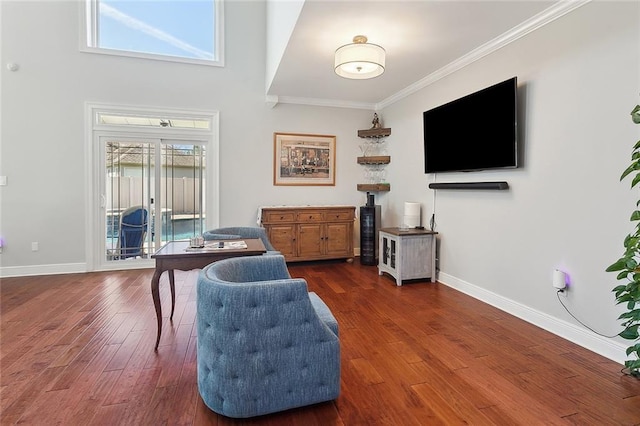 living area with dark wood-style floors, baseboards, and crown molding