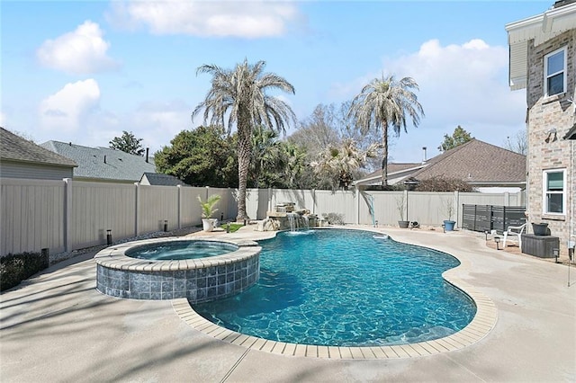 view of swimming pool featuring a pool with connected hot tub, a patio area, and a fenced backyard