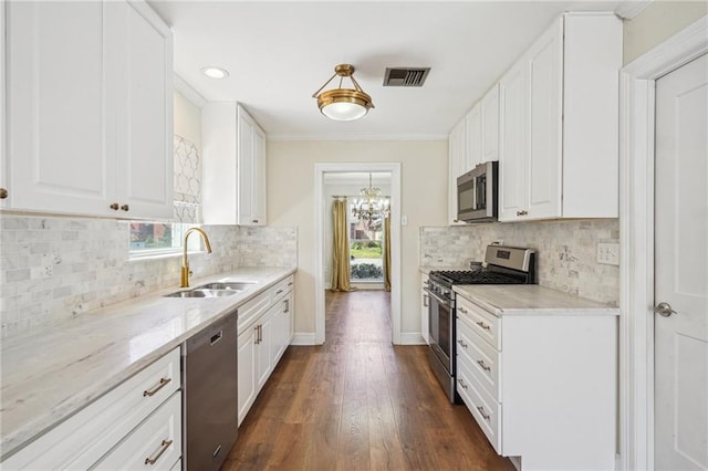 kitchen with white cabinetry, visible vents, stainless steel appliances, and a sink