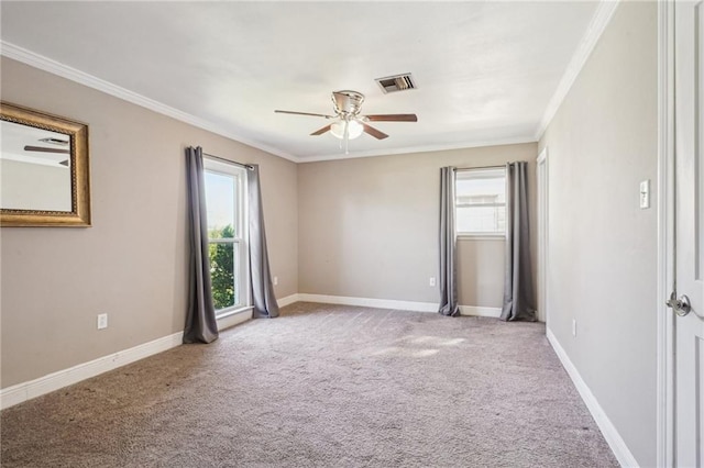 spare room featuring a healthy amount of sunlight, carpet floors, baseboards, and visible vents