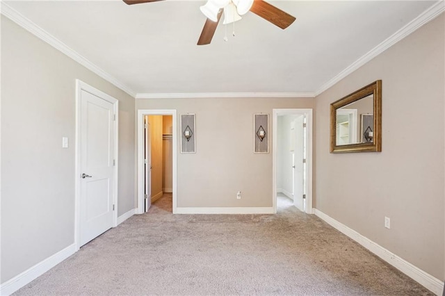 unfurnished bedroom with ornamental molding, carpet, and baseboards