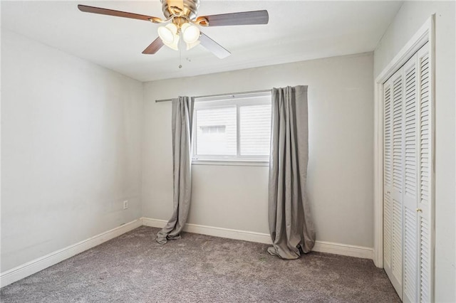 unfurnished bedroom with ceiling fan, carpet floors, a closet, and baseboards