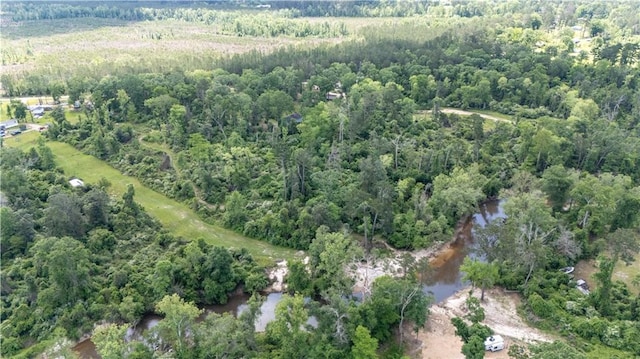 aerial view featuring a forest view and a water view