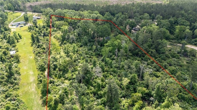 birds eye view of property featuring a view of trees