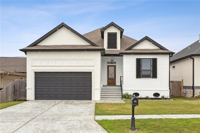 view of front of property featuring a garage, fence, a front lawn, and decorative driveway