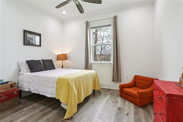 bedroom featuring ceiling fan, recessed lighting, wood finished floors, baseboards, and ornamental molding