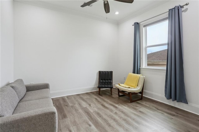 sitting room featuring baseboards, ceiling fan, wood finished floors, crown molding, and recessed lighting